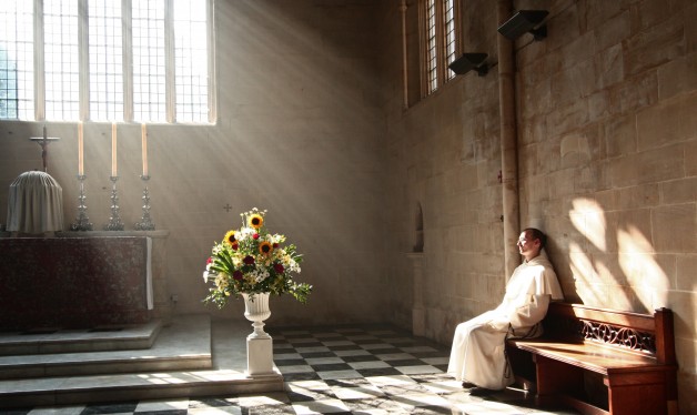 A Dominican friar prays in the presence of the Blessed Sacrament in Blackfriars church, Oxford.