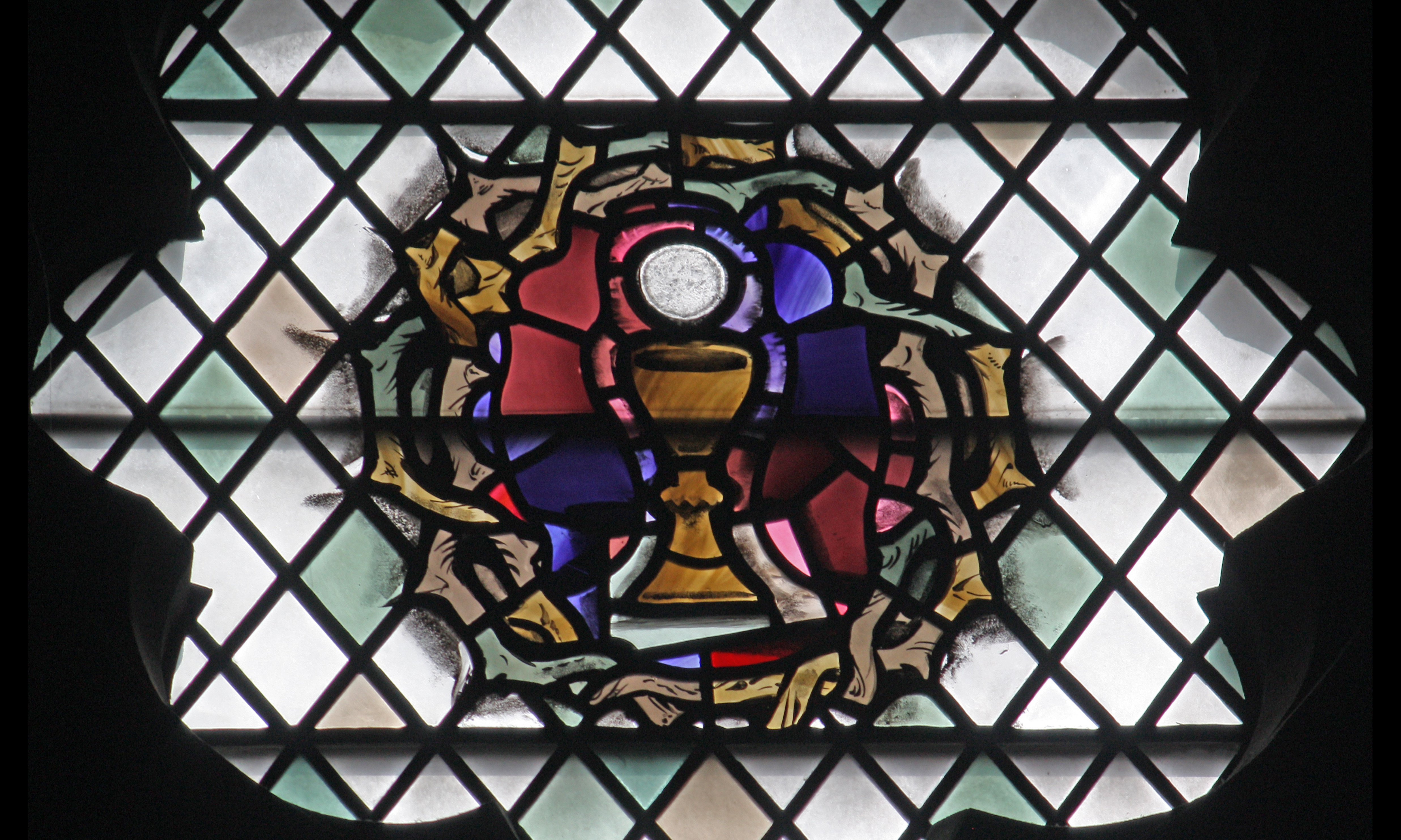 A chalice encircled by a crown of thorns.